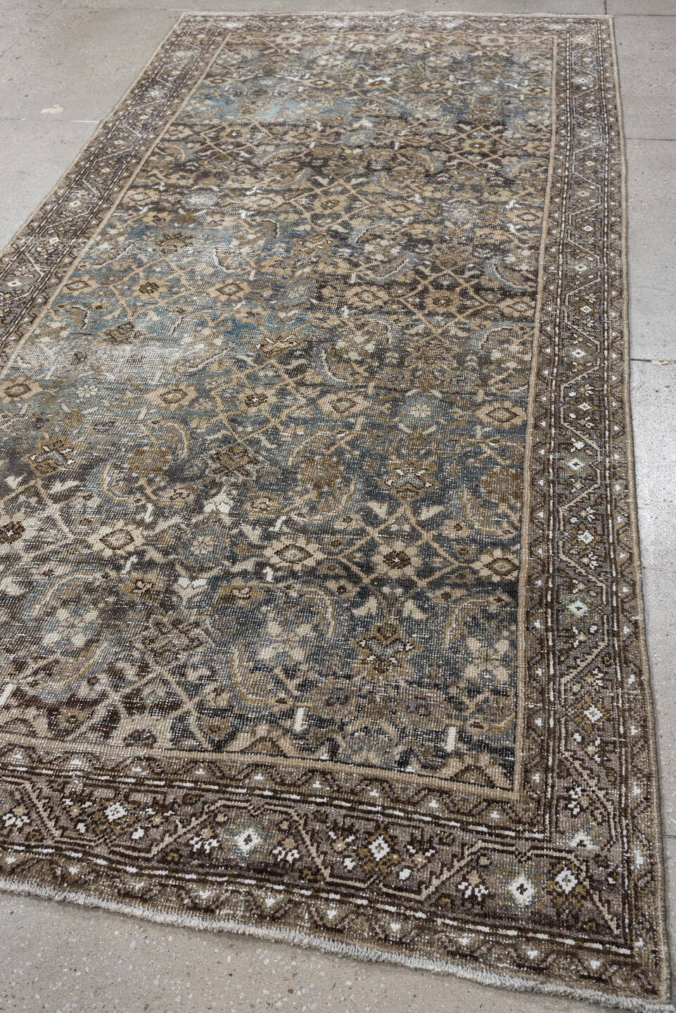 5' x 9' one-of-a-kind handmade antique Shiraz medium size rug. Color palette: taupe, brown, blue, ivory, charcoal, camel