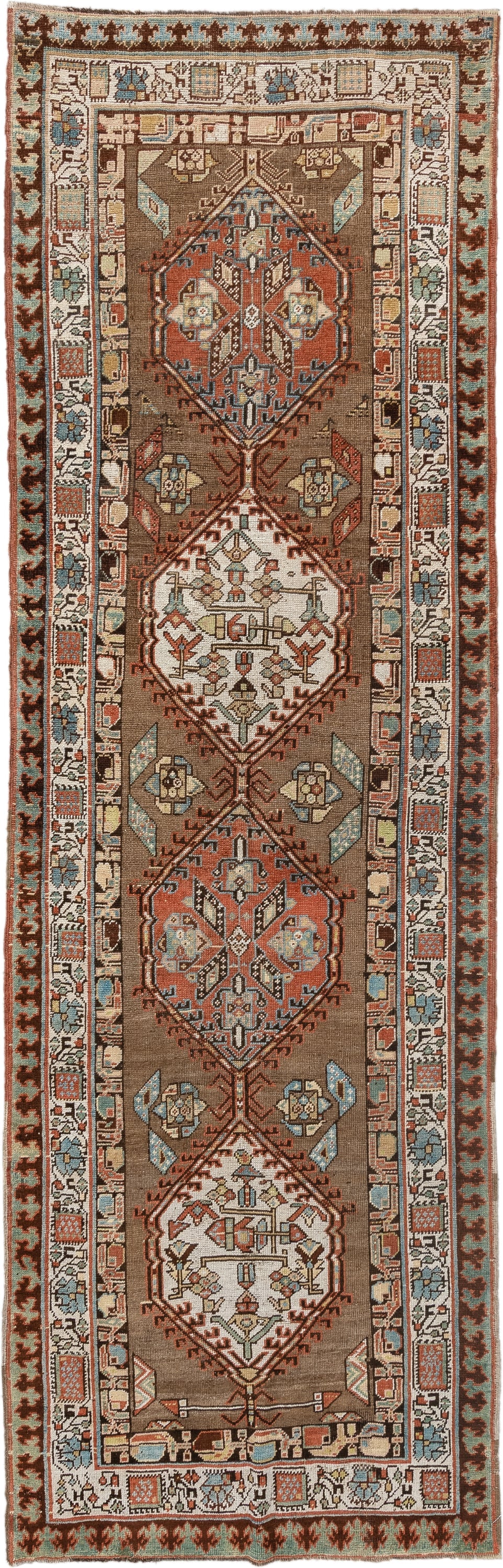 3' x 11' one-of-a-kind handmade antique Sarab runner rug. Color palette: brown, ivory, rust, sky blue, camel, terra cotta