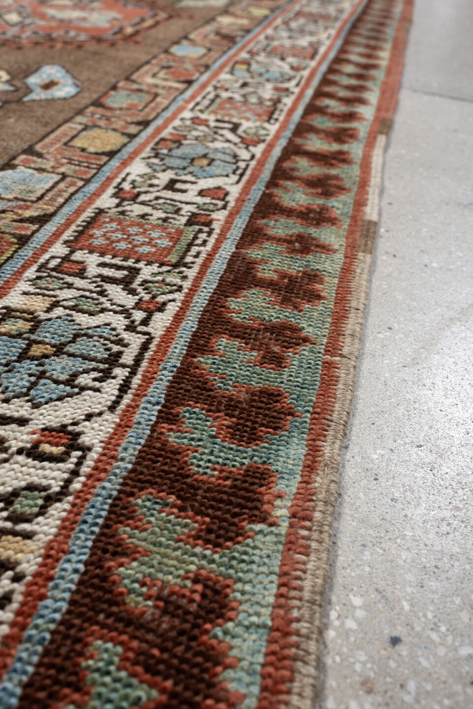 3' x 11' one-of-a-kind handmade antique Sarab runner rug. Color palette: brown, ivory, rust, sky blue, camel, terra cotta