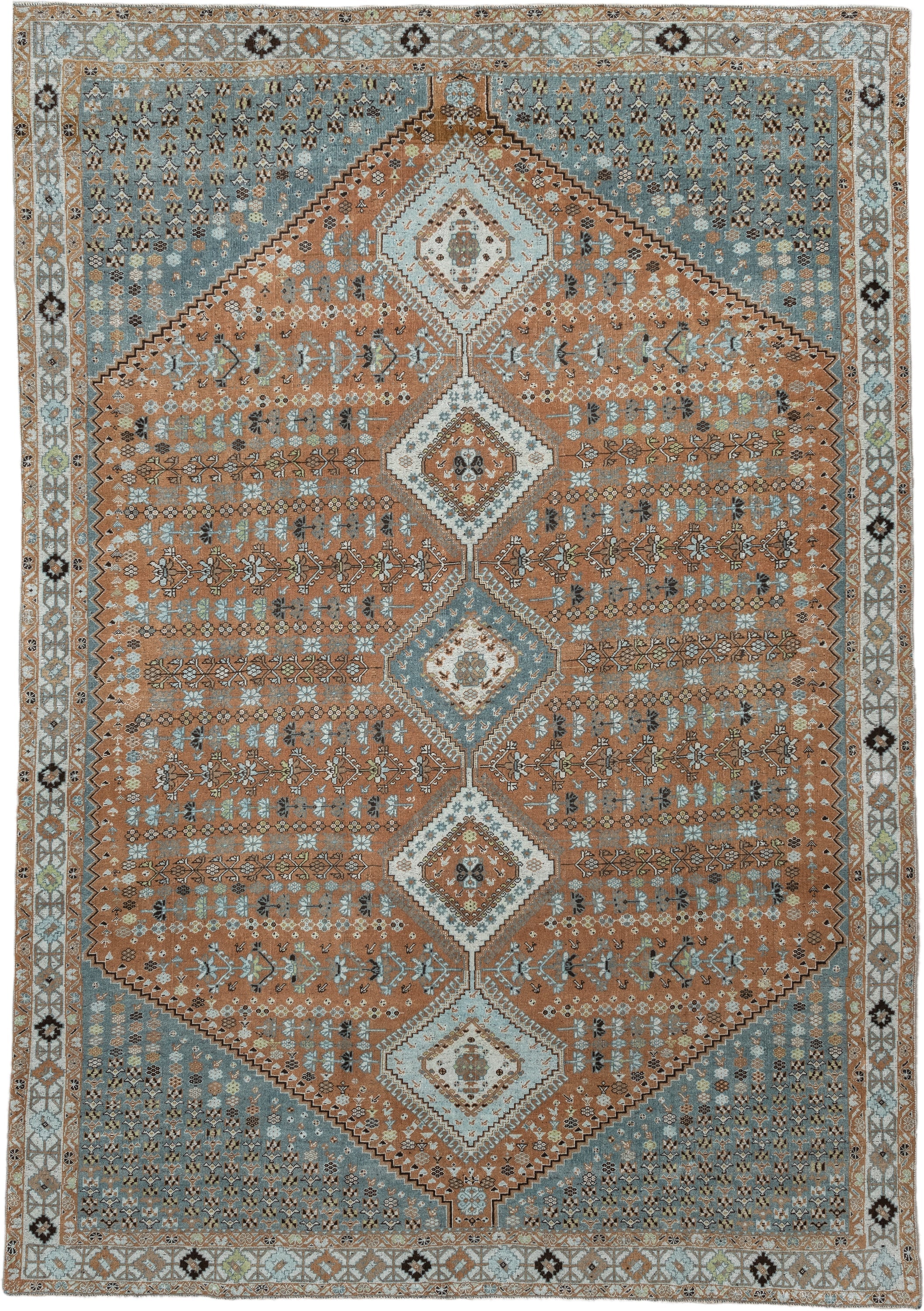 6' x 9' one-of-a-kind handmade antique Shiraz rug. Color palette: terra cotta, sky blue, ivory, camel, charcoal, sage, taupe