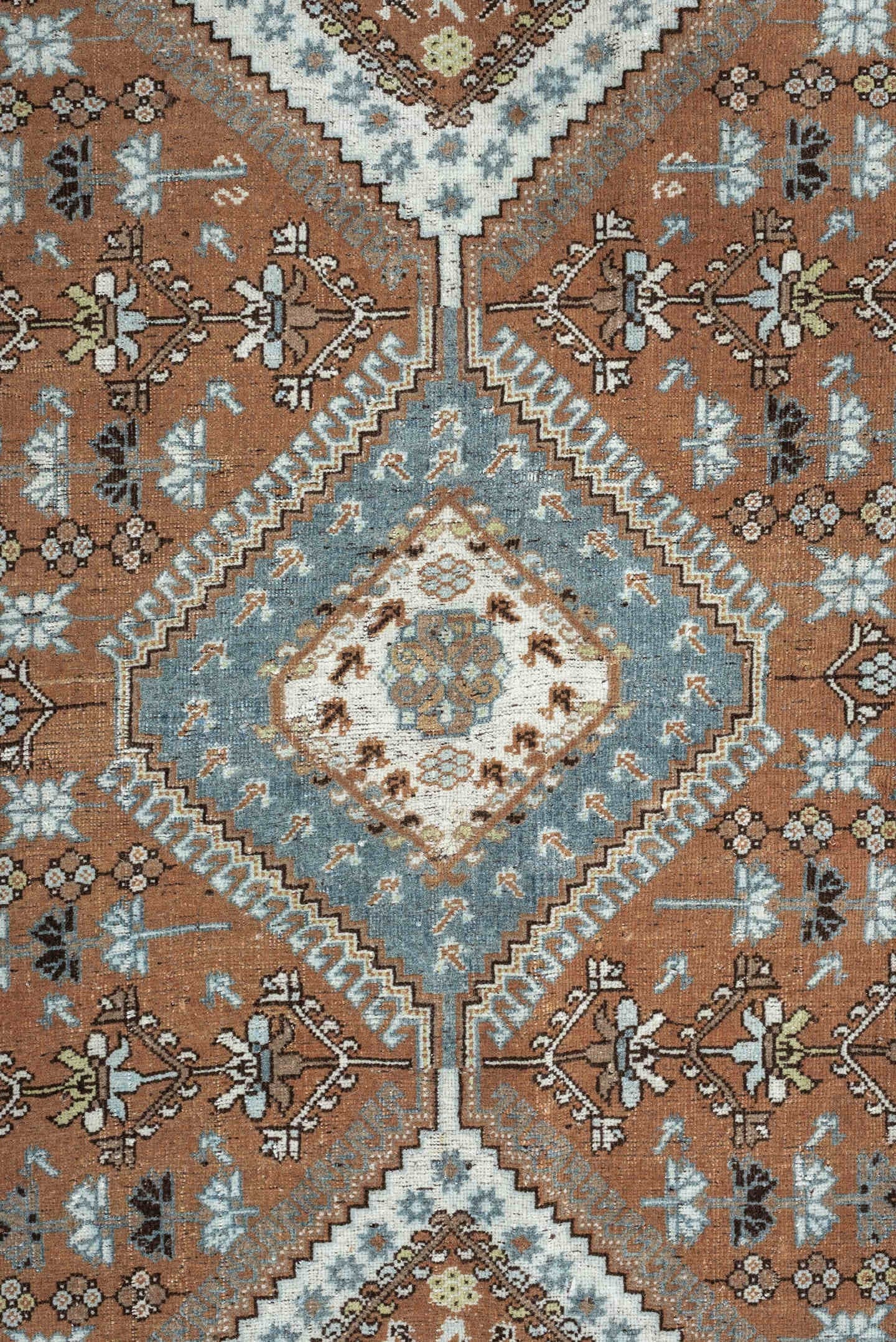 6' x 9' one-of-a-kind handmade antique Shiraz rug. Color palette: terra cotta, sky blue, ivory, camel, charcoal, sage, taupe