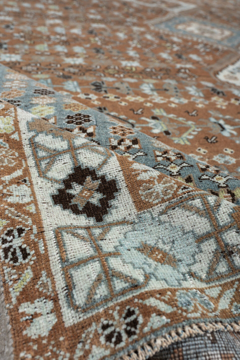 6' x 9' one-of-a-kind handmade antique Shiraz rug. Color palette: terra cotta, sky blue, ivory, camel, charcoal, sage, taupe