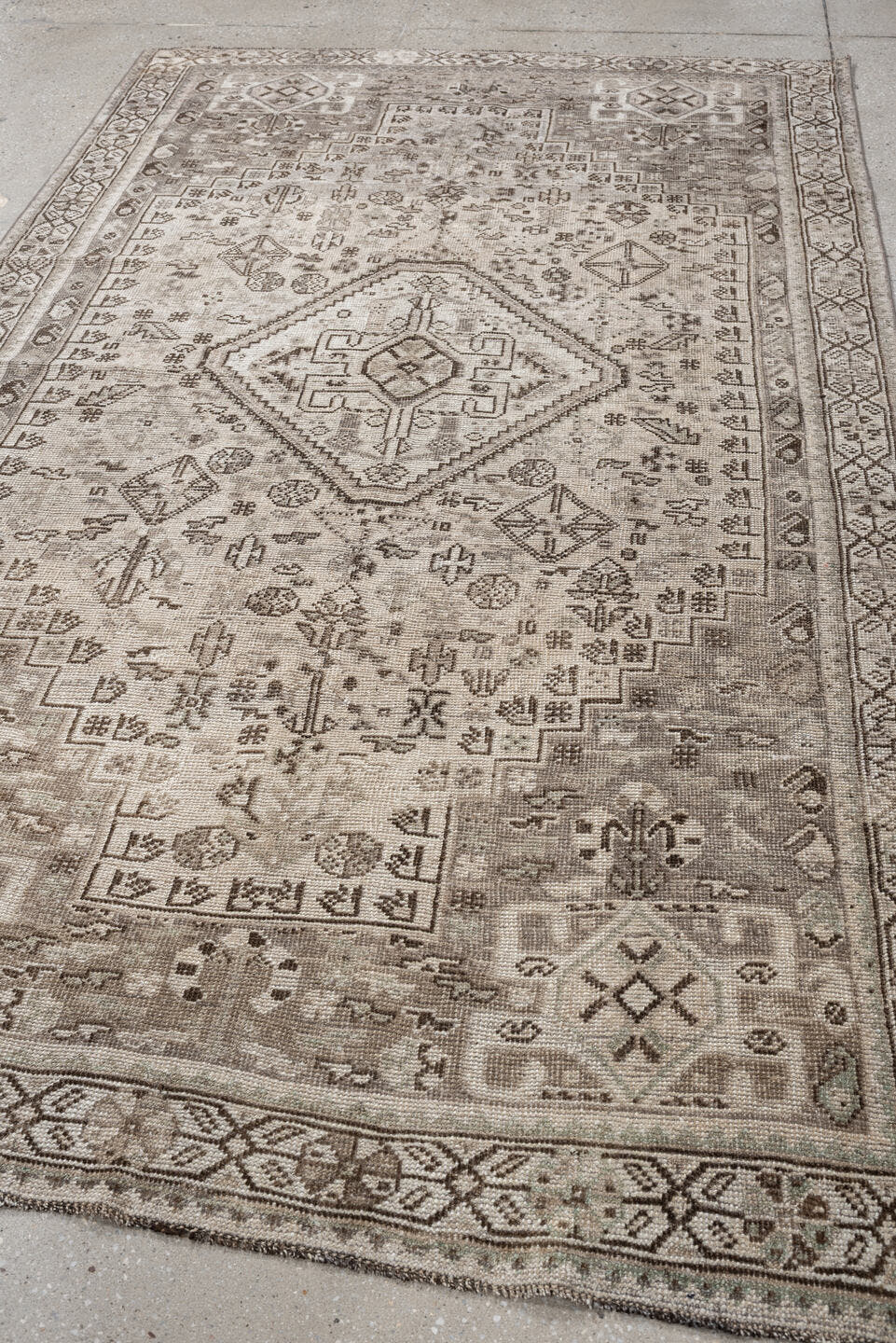 4' x 8' one-of-a-kind handmade antique Shiraz medium size rug. Color palette: taupe, ivory, brown, gray, beige