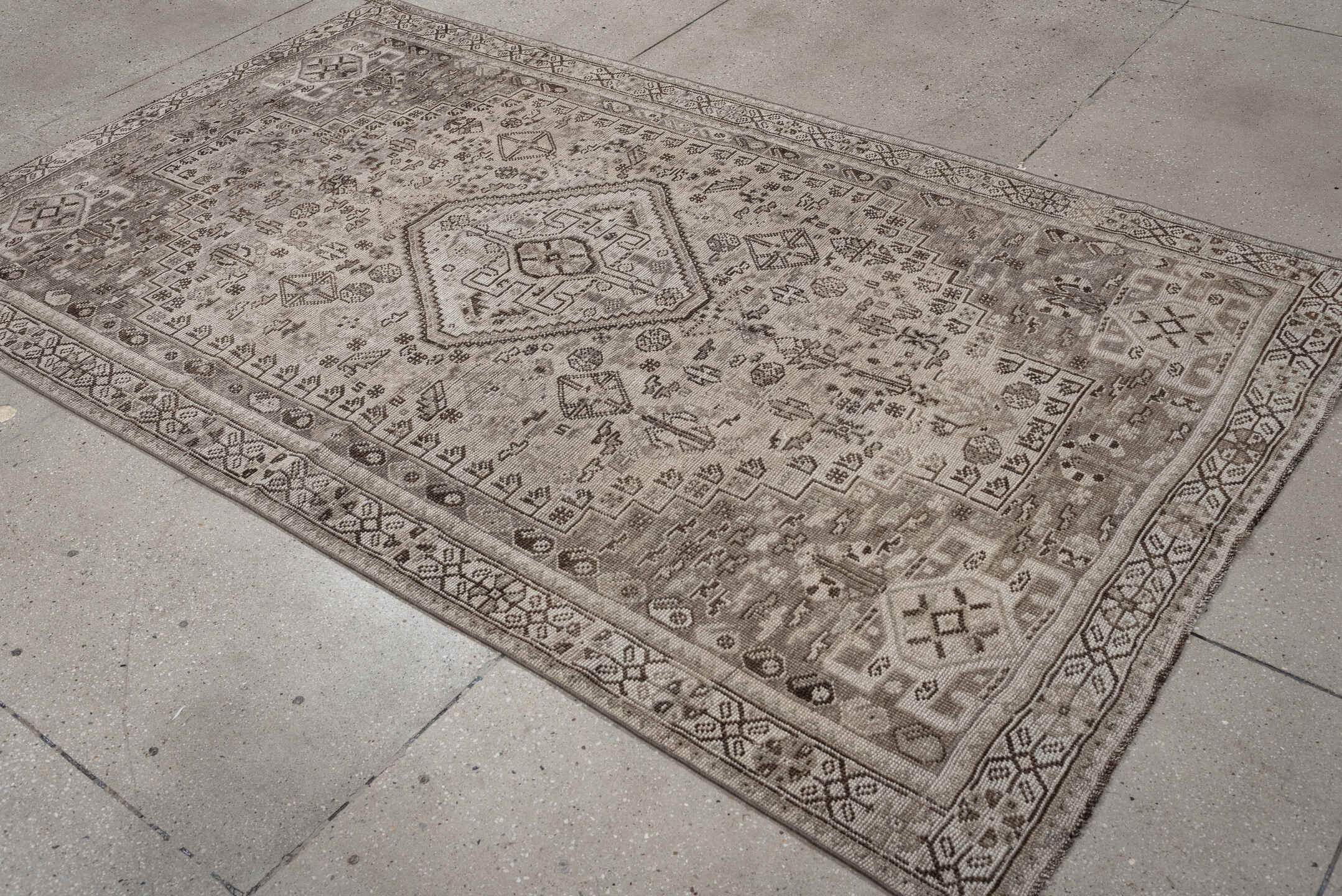 4' x 8' one-of-a-kind handmade antique Shiraz medium size rug. Color palette: taupe, ivory, brown, gray, beige