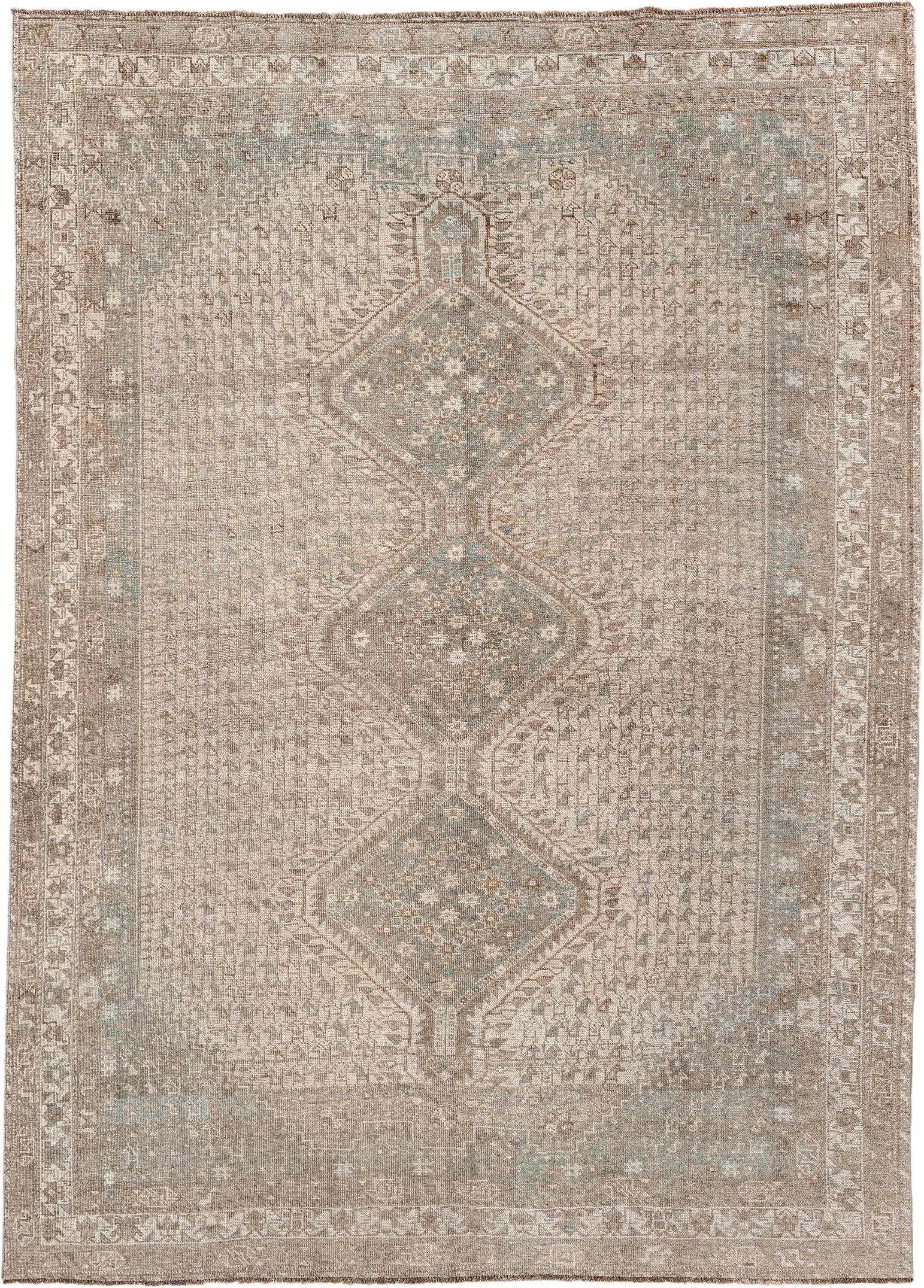 6' x 9' one-of-a-kind handmade antique Shiraz rug. Color palette: taupe, ivory, pale blue, beige, sand, camel, gray