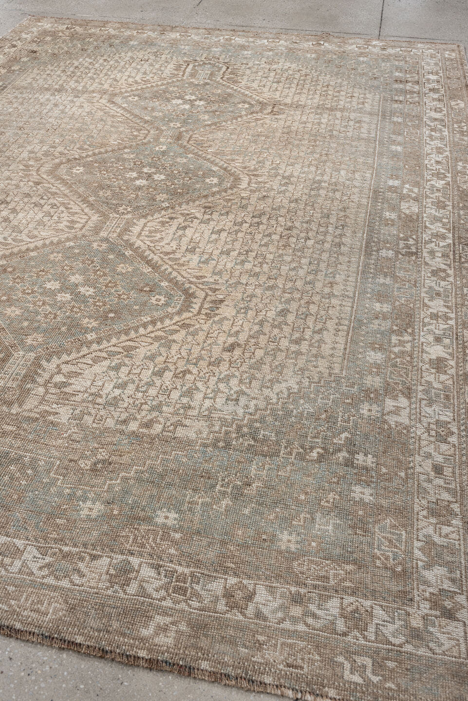 6' x 9' one-of-a-kind handmade antique Shiraz rug. Color palette: taupe, ivory, pale blue, beige, sand, camel, gray