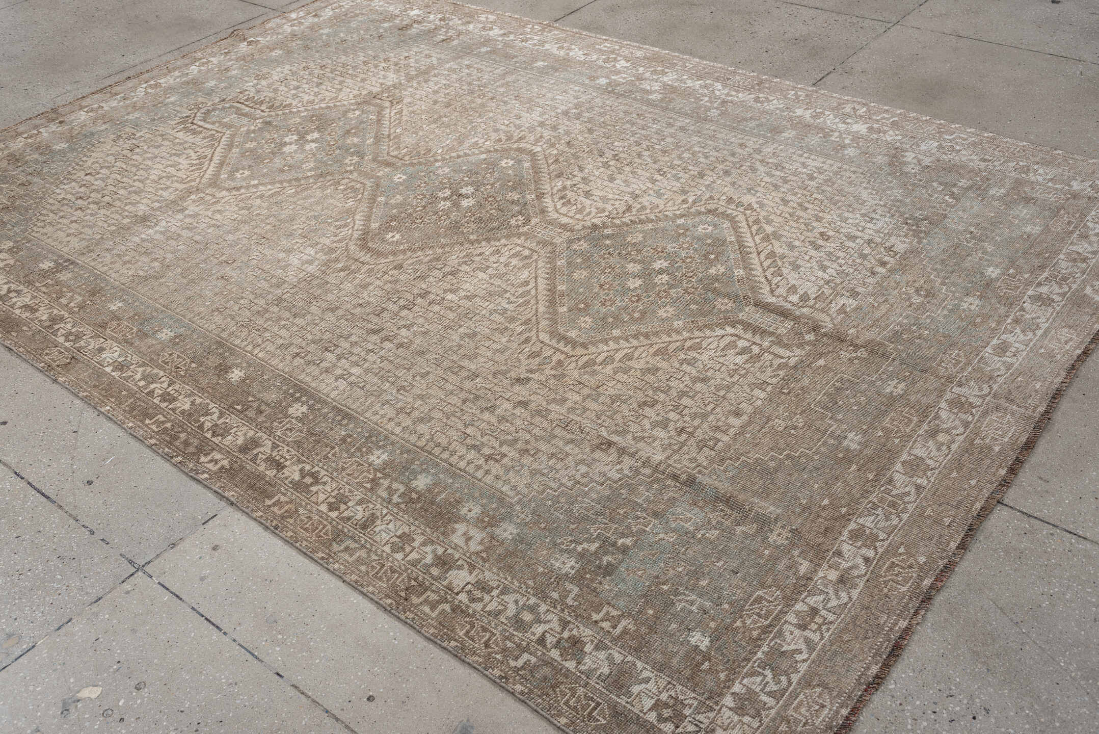 6' x 9' one-of-a-kind handmade antique Shiraz rug. Color palette: taupe, ivory, pale blue, beige, sand, camel, gray