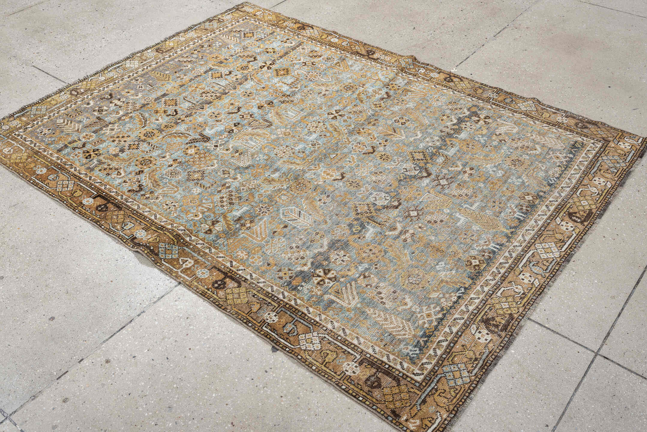 4' x 6' one-of-a-kind handmade antique Shiraz rug. Color palette: sky blue, camel, ivory, taupe, brown, slate, gold
