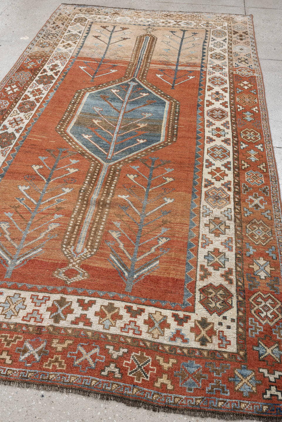 5' x 9' one-of-a-kind handmade antique Kurd medium size rug. Color palette: terra cotta, ivory, sky blue, brown, slate, rust