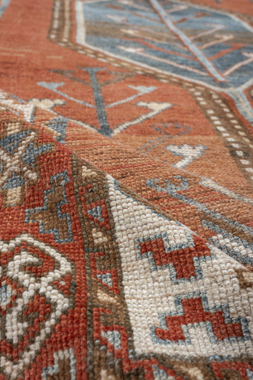 5' x 9' one-of-a-kind handmade antique Kurd medium size rug. Color palette: terra cotta, ivory, sky blue, brown, slate, rust