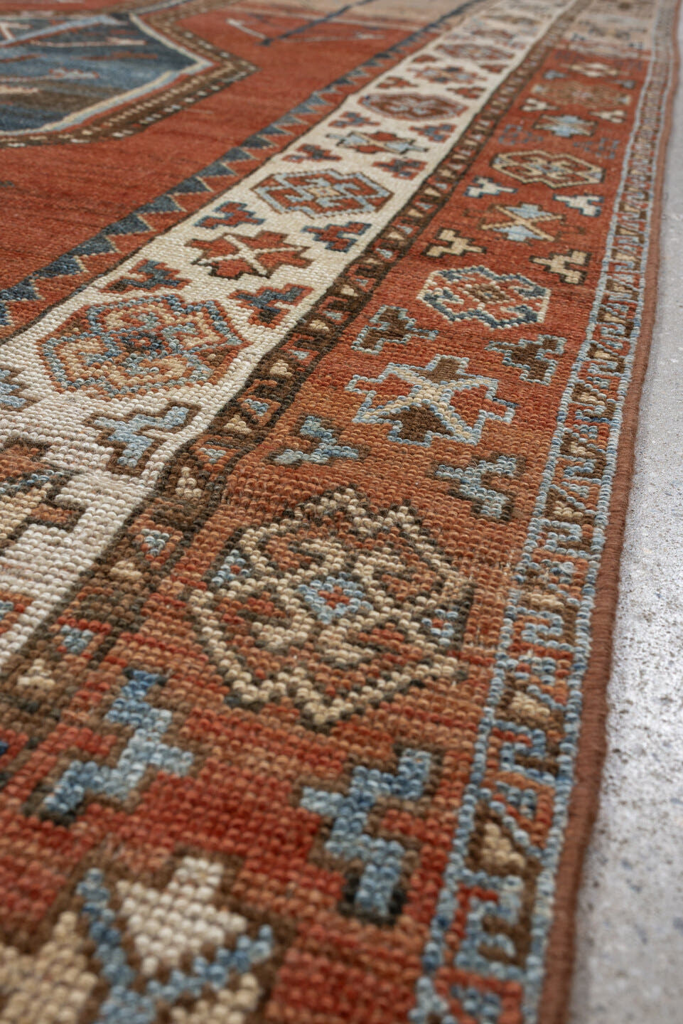 5' x 9' one-of-a-kind handmade antique Kurd medium size rug. Color palette: terra cotta, ivory, sky blue, brown, slate, rust