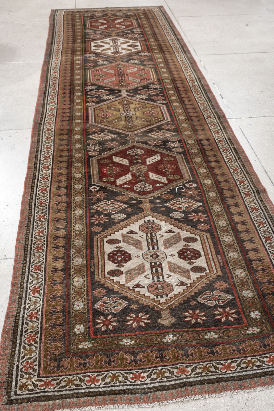 3' x 12' one-of-a-kind handmade antique Kurd runner rug. Color palette: brown, ivory, rust, camel, taupe, burgundy, olive