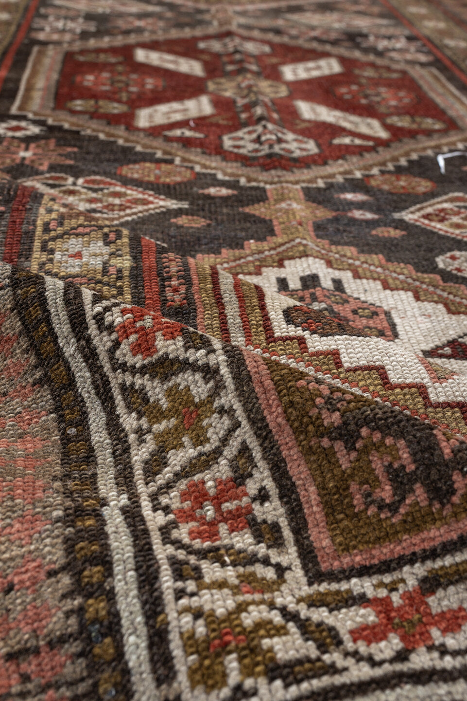 3' x 12' one-of-a-kind handmade antique Kurd runner rug. Color palette: brown, ivory, rust, camel, taupe, burgundy, olive