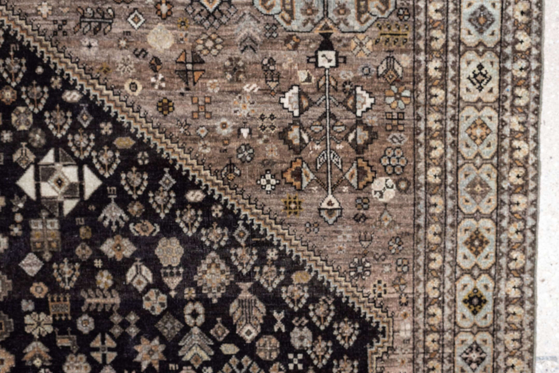 5' x 6' one-of-a-kind handmade antique Afshar rug. Color palette: charcoal, ivory, taupe, rust, pale blue, brown, camel