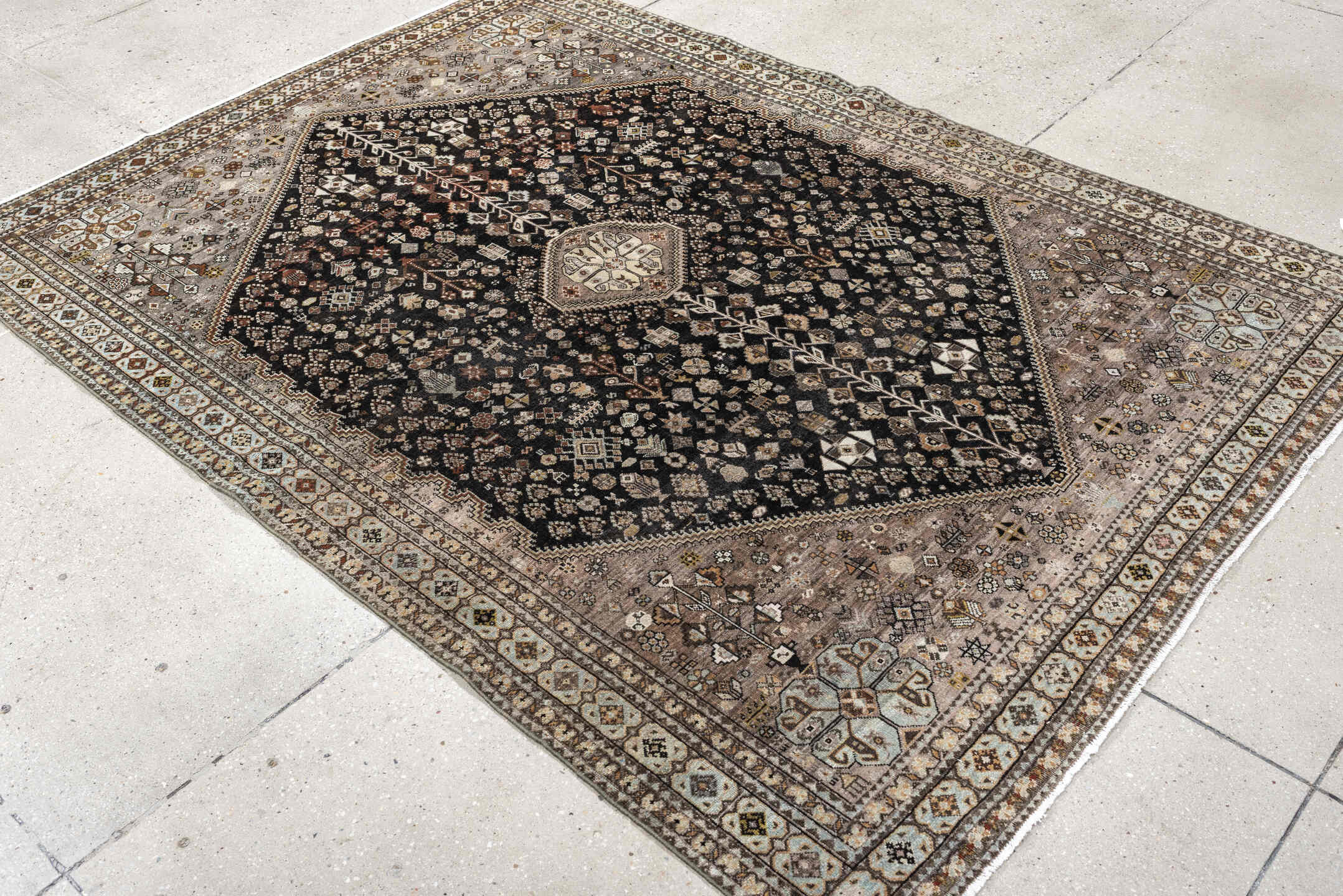 5' x 6' one-of-a-kind handmade antique Afshar rug. Color palette: charcoal, ivory, taupe, rust, pale blue, brown, camel