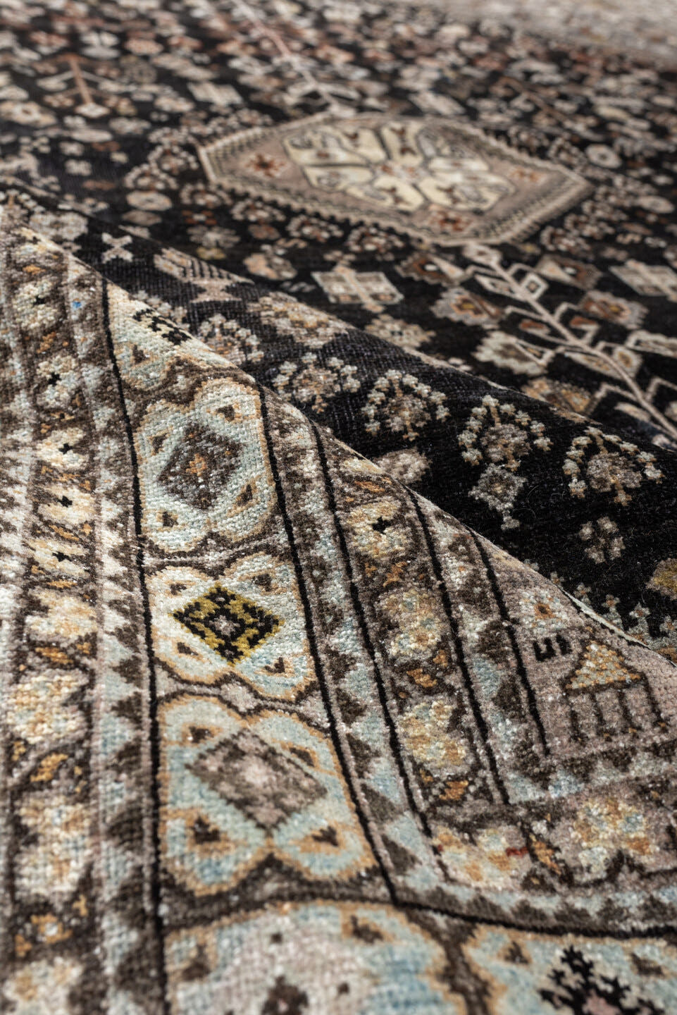 5' x 6' one-of-a-kind handmade antique Afshar rug. Color palette: charcoal, ivory, taupe, rust, pale blue, brown, camel
