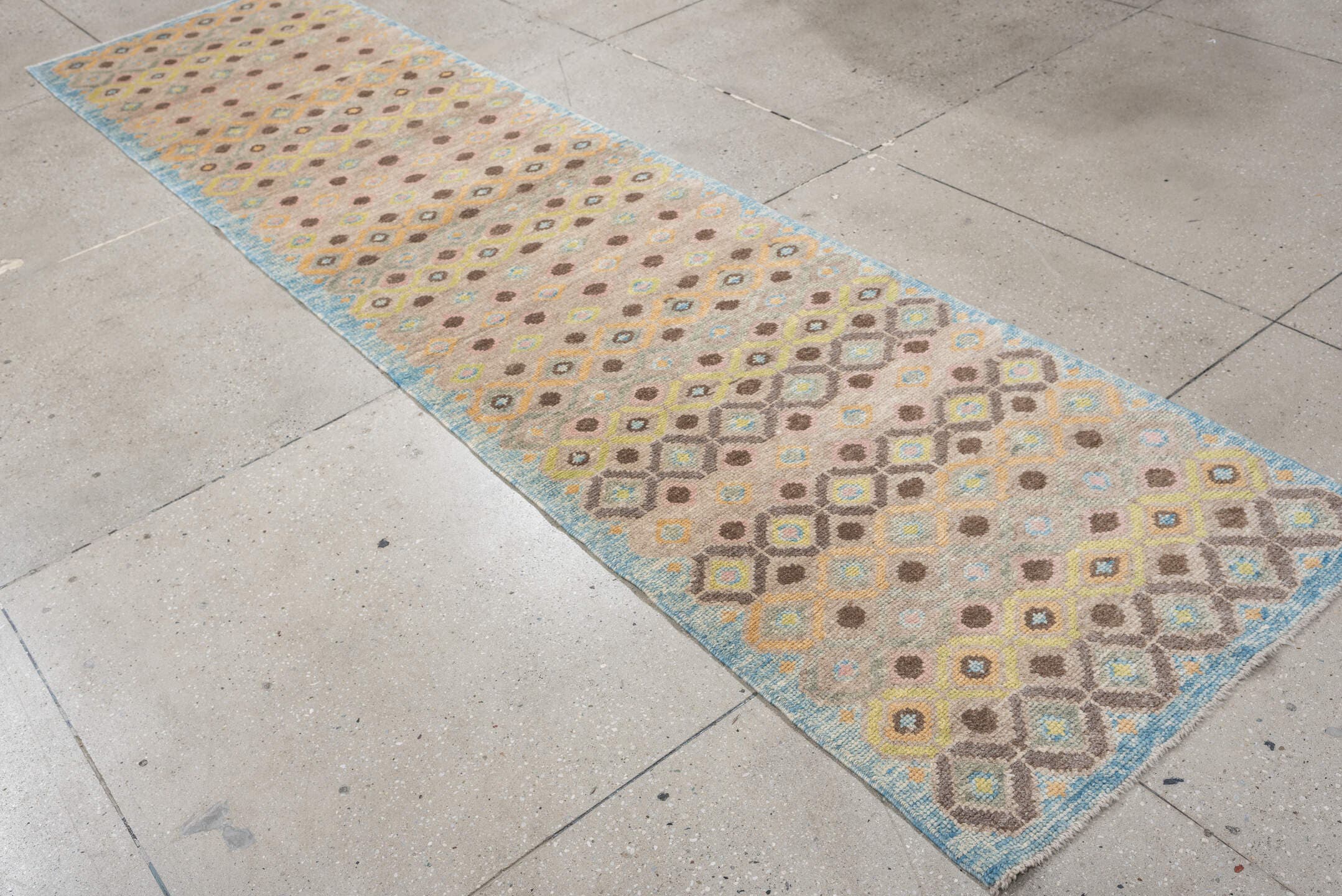 2' x 11' one-of-a-kind handmade vintage Oushak runner rug. Color palette: taupe, sky blue, camel, brown, ivory, sage, gold