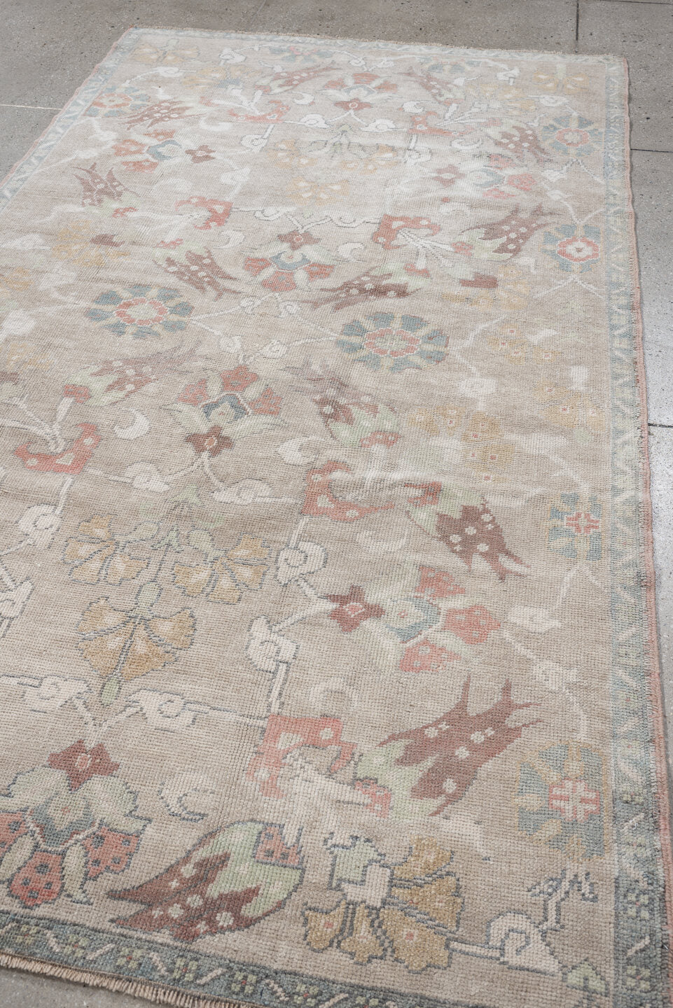 4' x 8' one-of-a-kind handmade antique Oushak rug. Color palette: taupe, ivory, pale blue, coral, soft gold, rose, sage