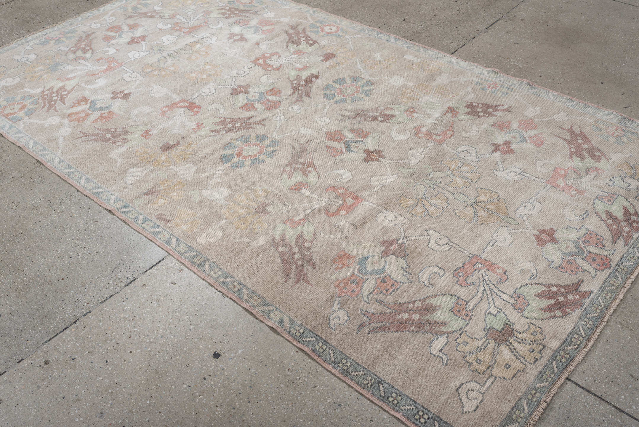 4' x 8' one-of-a-kind handmade antique Oushak rug. Color palette: taupe, ivory, pale blue, coral, soft gold, rose, sage