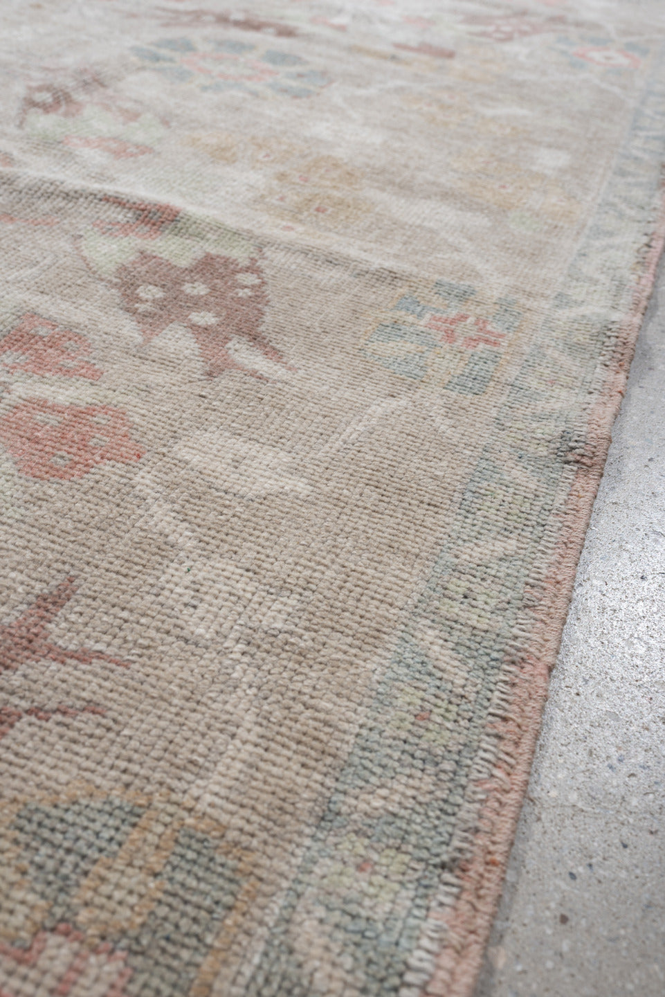 4' x 8' one-of-a-kind handmade antique Oushak rug. Color palette: taupe, ivory, pale blue, coral, soft gold, rose, sage