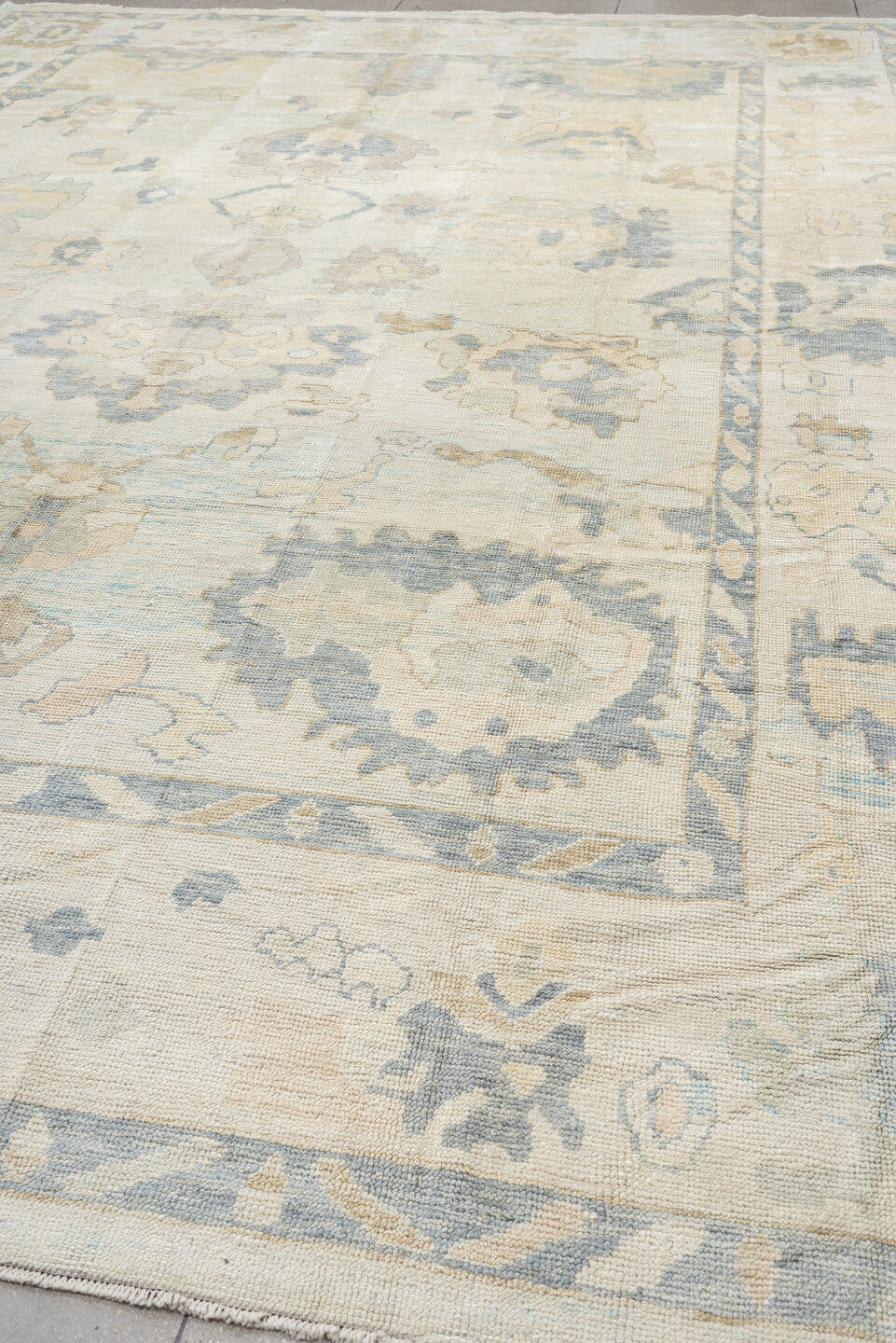12' x 17' one-of-a-kind handmade vintage Oushak oversize rug. Color palette: ivory, pale blue, beige, taupe, cream, sage