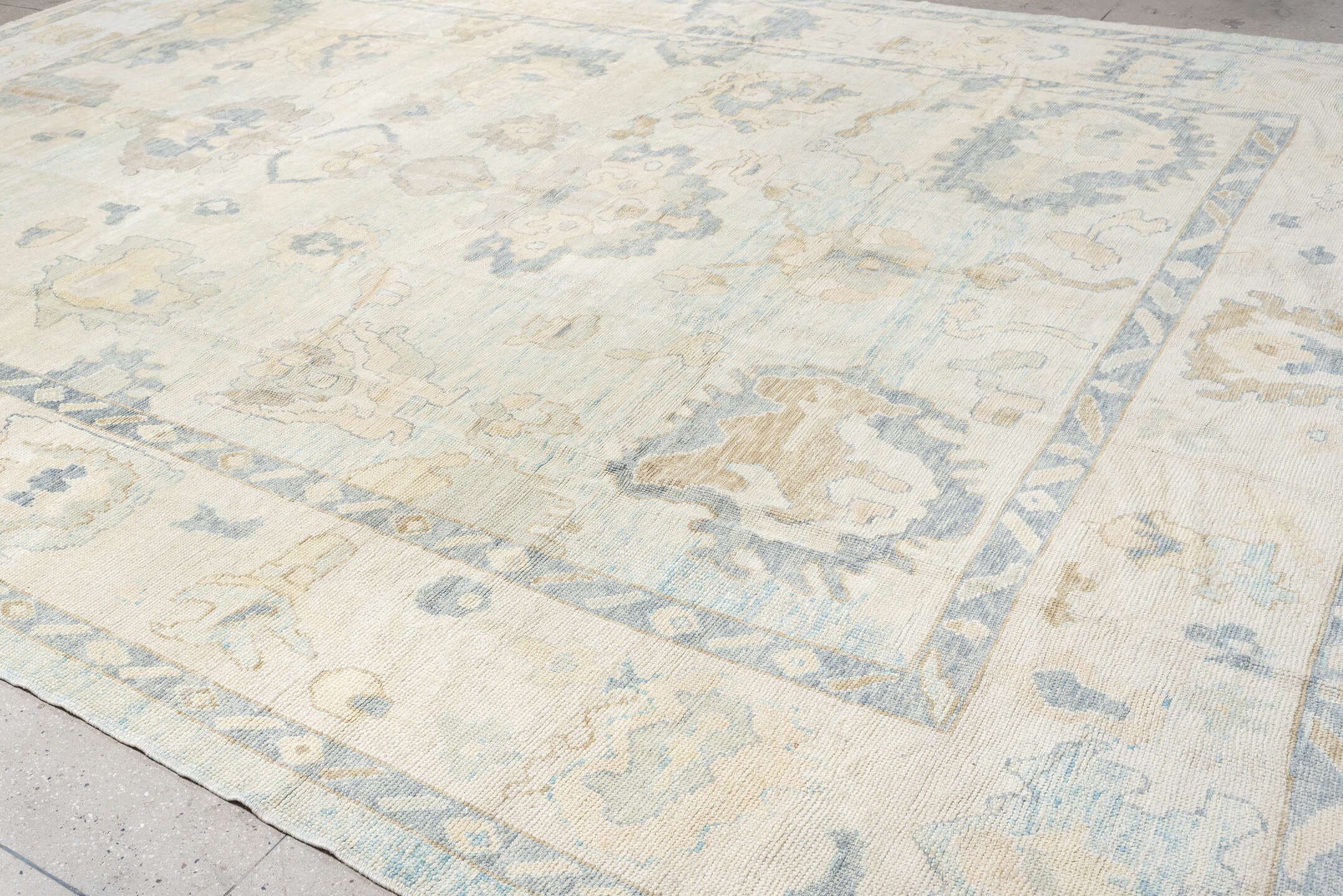 12' x 17' one-of-a-kind handmade vintage Oushak oversize rug. Color palette: ivory, pale blue, beige, taupe, cream, sage