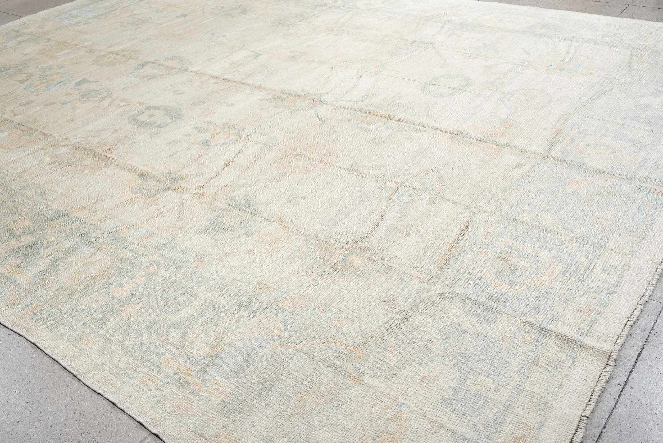 12' x 16' one-of-a-kind handmade vintage Oushak oversize rug. Color palette: ivory, pale blue, cream, taupe, blush, sage