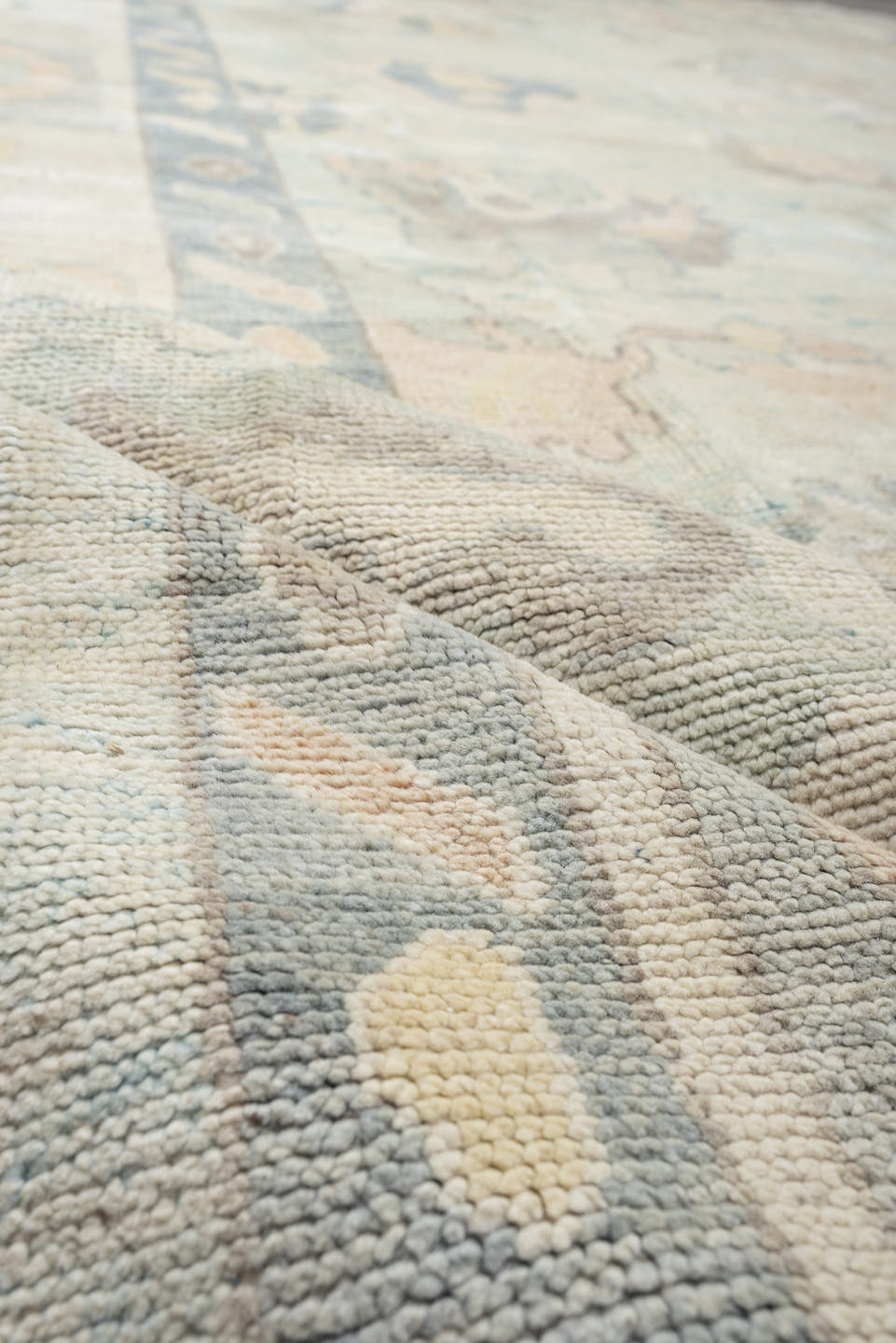 12' x 15' one-of-a-kind handmade vintage Oushak oversize rug. Color palette: ivory, pale blue, sky blue, taupe, beige, sage
