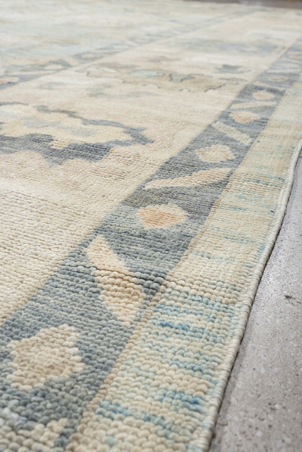 12' x 15' one-of-a-kind handmade vintage Oushak oversize rug. Color palette: ivory, pale blue, sky blue, taupe, beige, sage