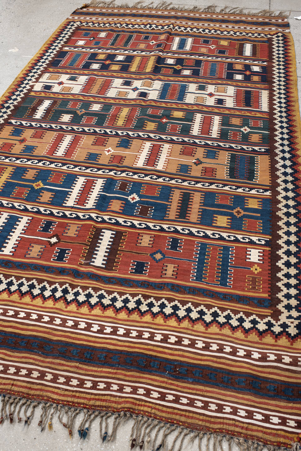 5' x 9' one-of-a-kind handmade vintage Kilim medium size rug. Color palette: rust, ivory, indigo, camel, teal, brown, navy