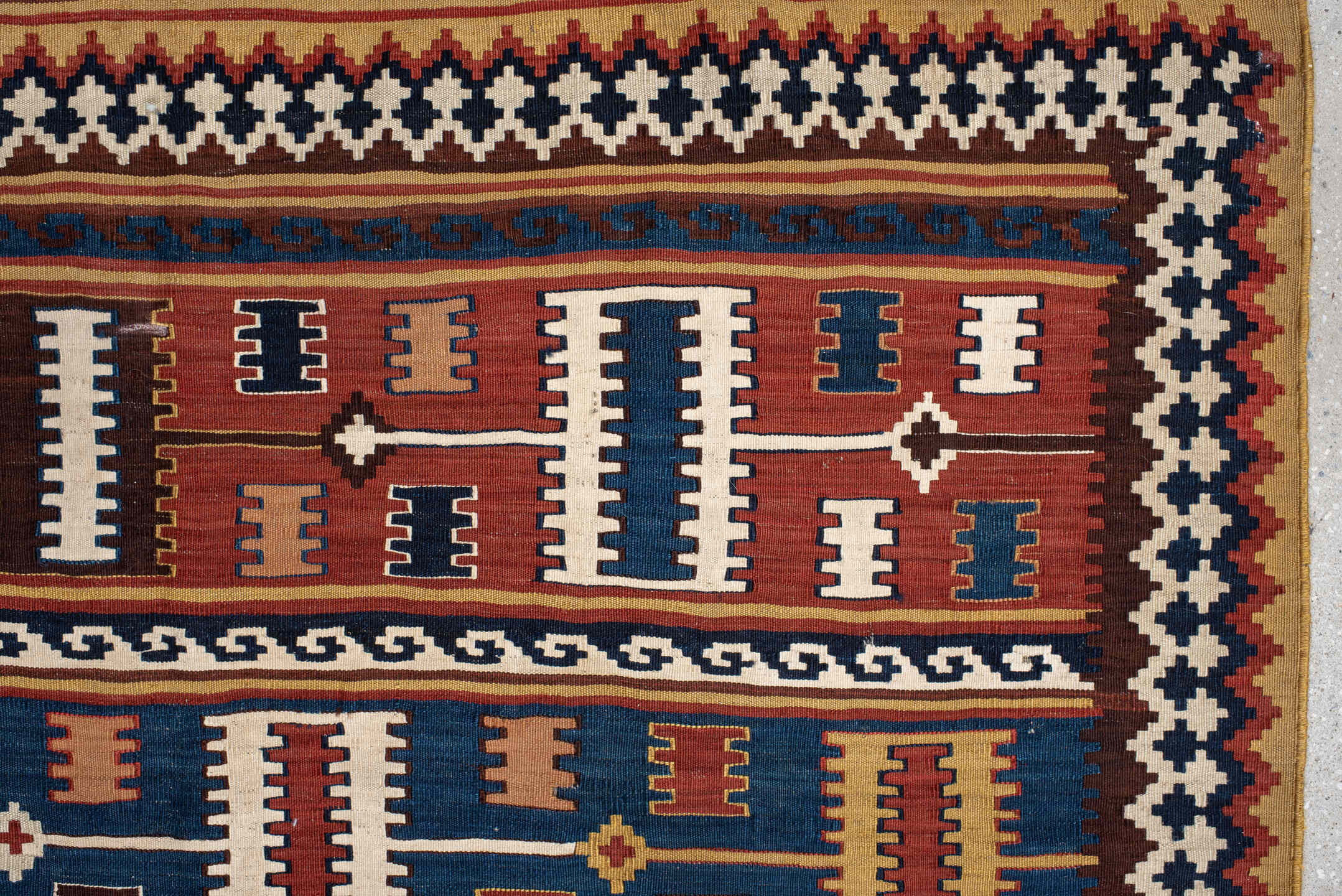 5' x 9' one-of-a-kind handmade vintage Kilim medium size rug. Color palette: rust, ivory, indigo, camel, teal, brown, navy