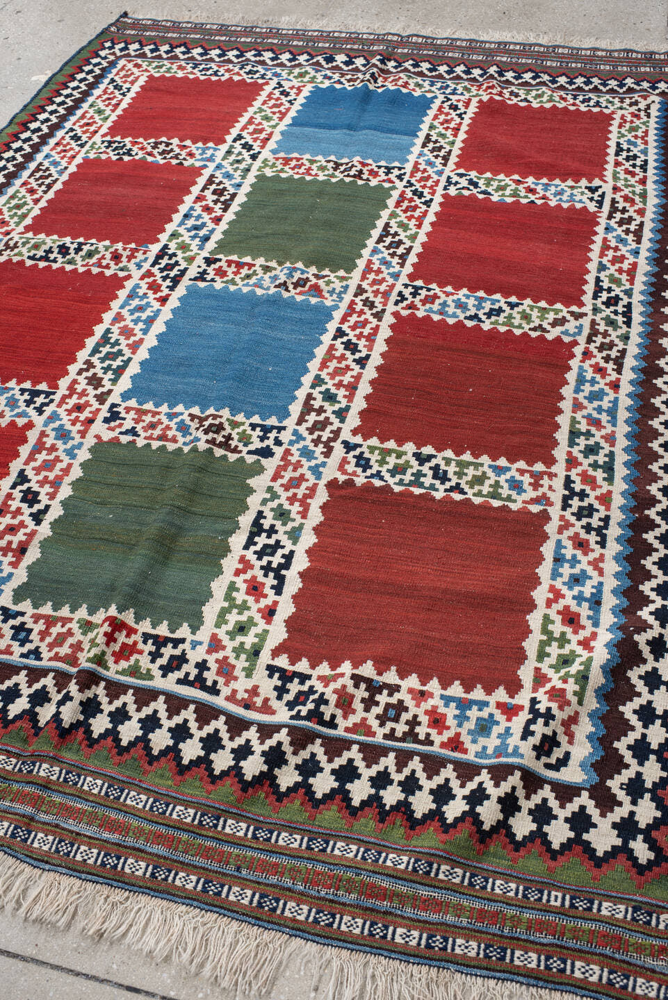 5' x 7' one-of-a-kind handmade vintage Kilim rug. Color palette: rust, ivory, navy, sky_blue, olive, red, teal, brown