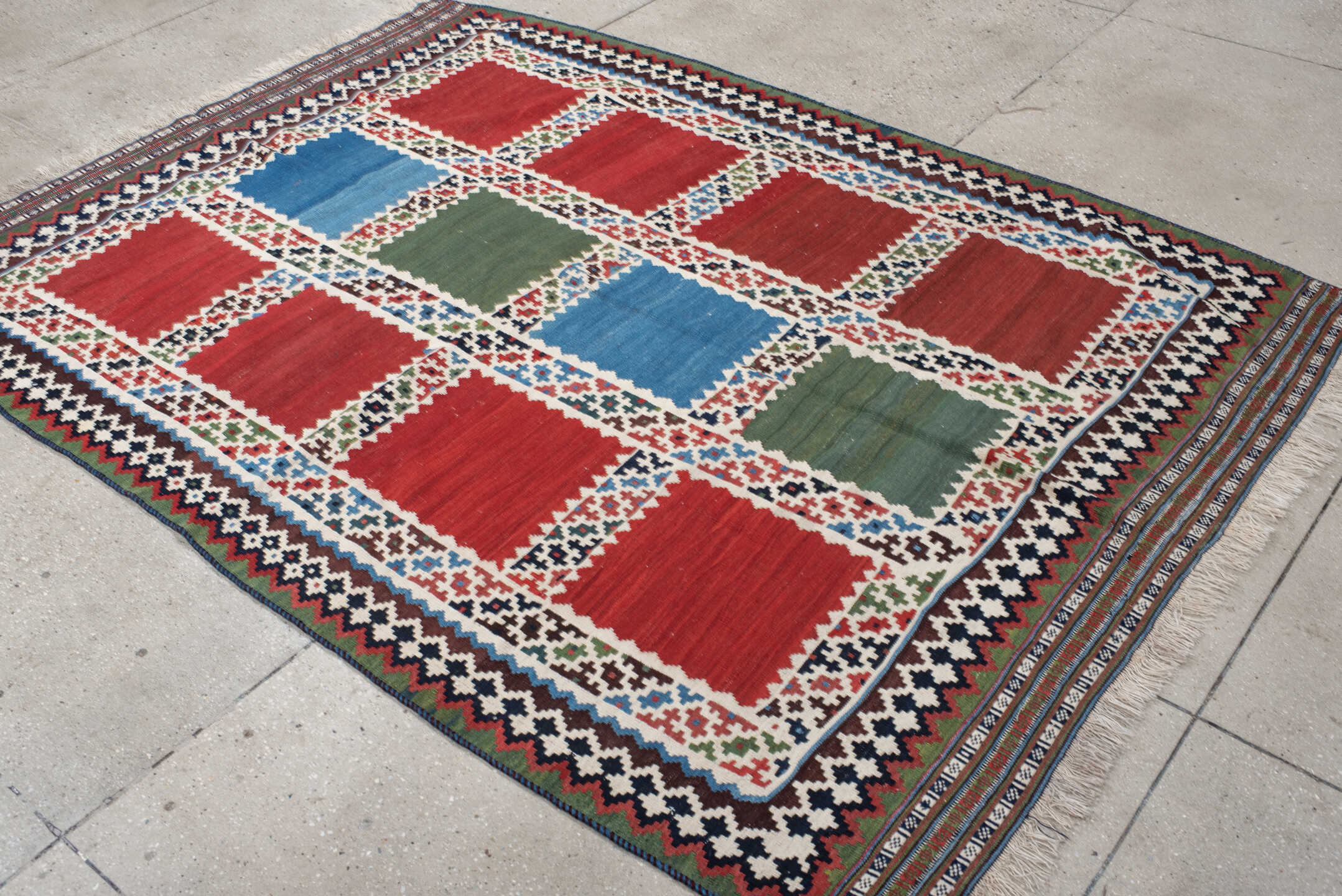 5' x 7' one-of-a-kind handmade vintage Kilim rug. Color palette: rust, ivory, navy, sky_blue, olive, red, teal, brown