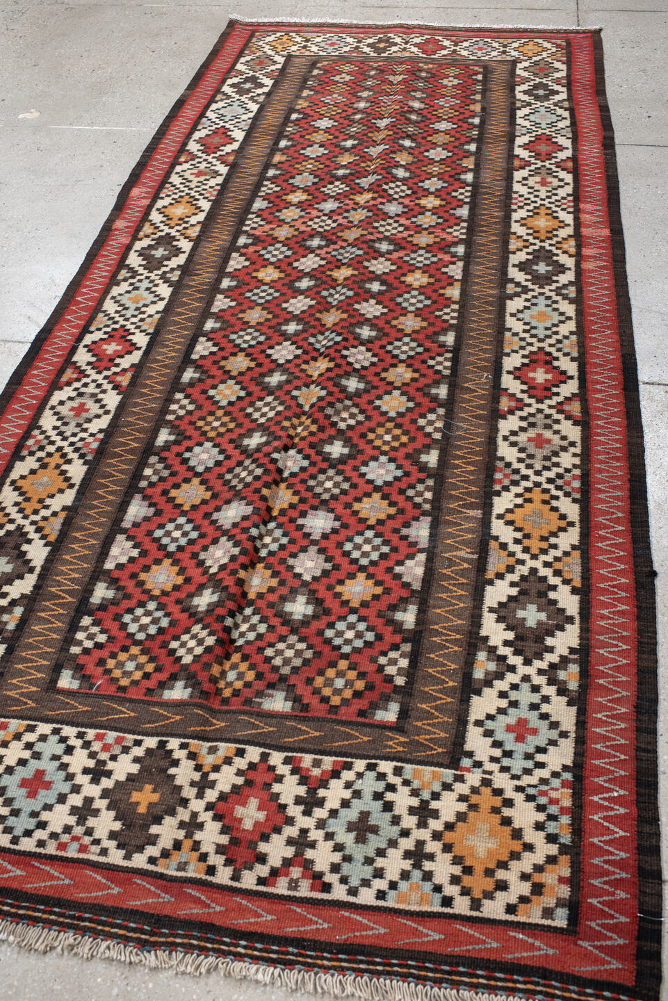 4' x 9' one-of-a-kind handmade vintage Kilim runner rug. Color palette: rust, ivory, charcoal, brown, sky blue, saffron