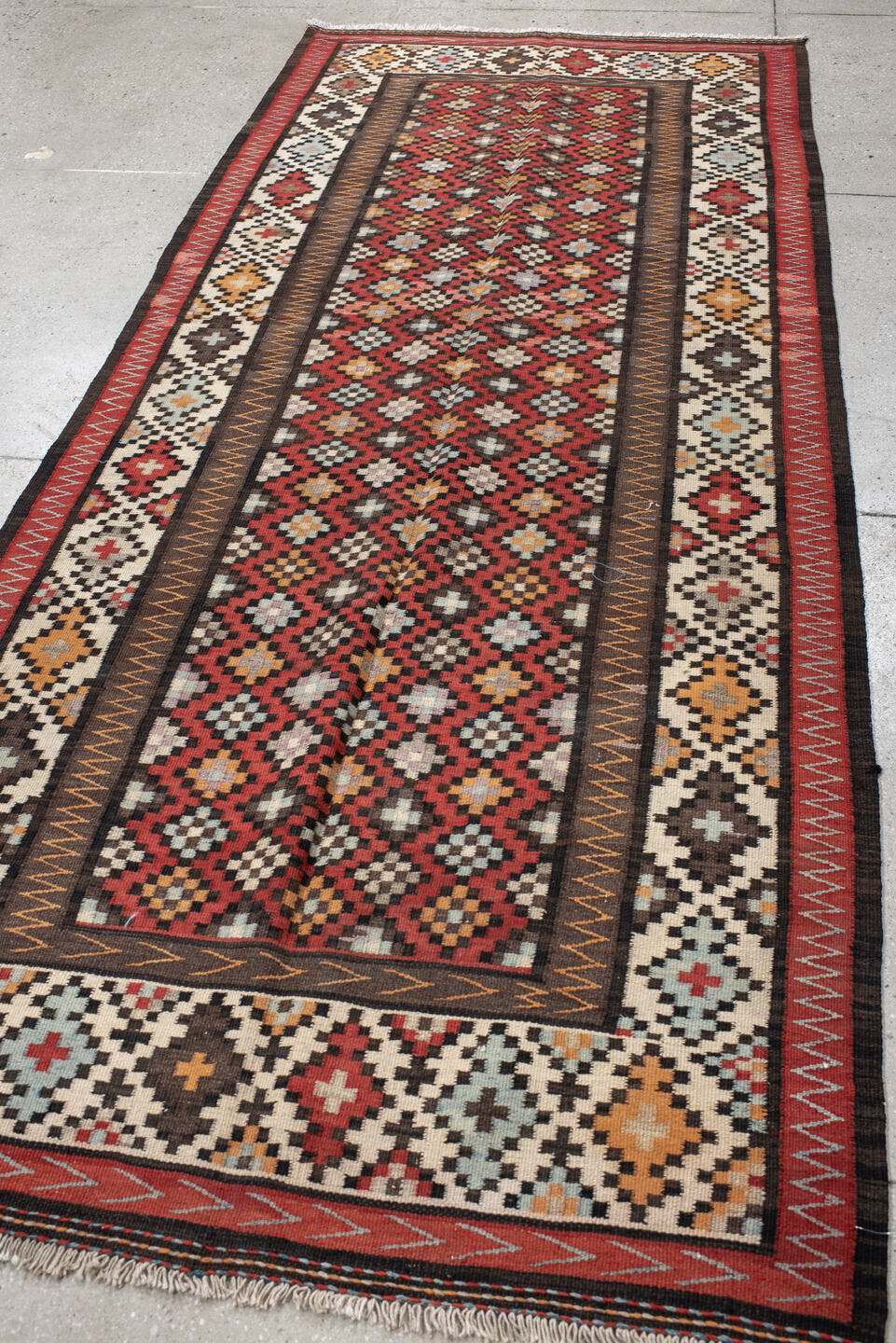 4' x 9' one-of-a-kind handmade vintage Kilim runner rug. Color palette: rust, ivory, charcoal, brown, sky blue, saffron