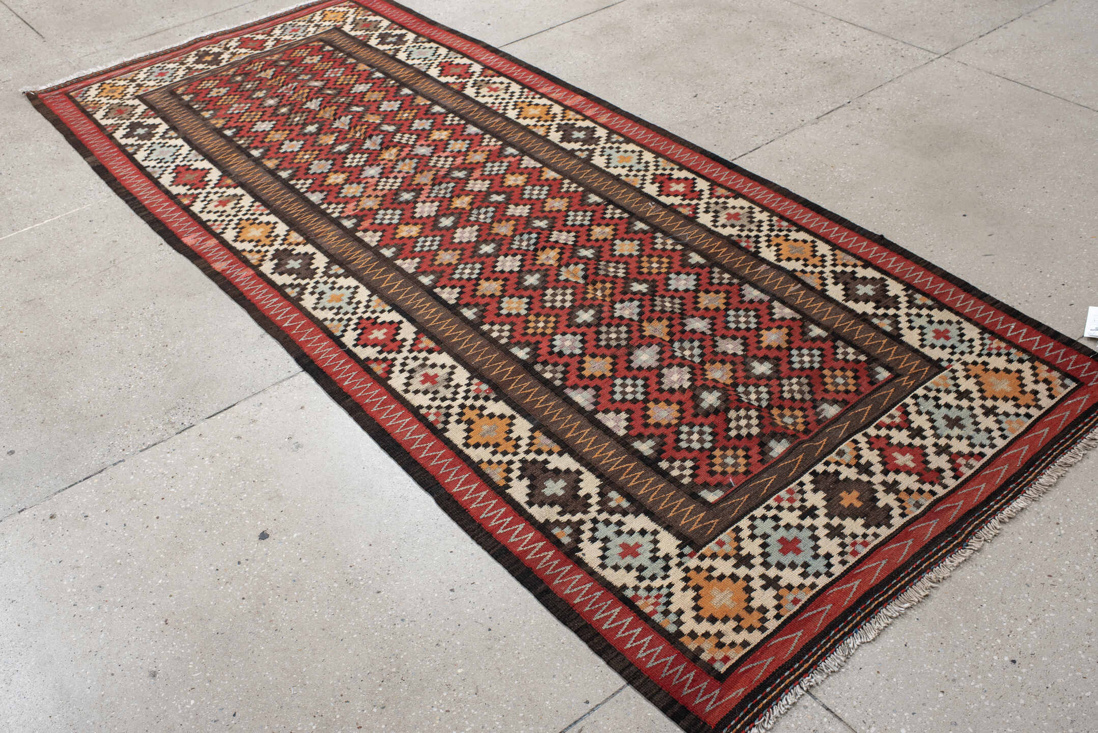 4' x 9' one-of-a-kind handmade vintage Kilim runner rug. Color palette: rust, ivory, charcoal, brown, sky blue, saffron