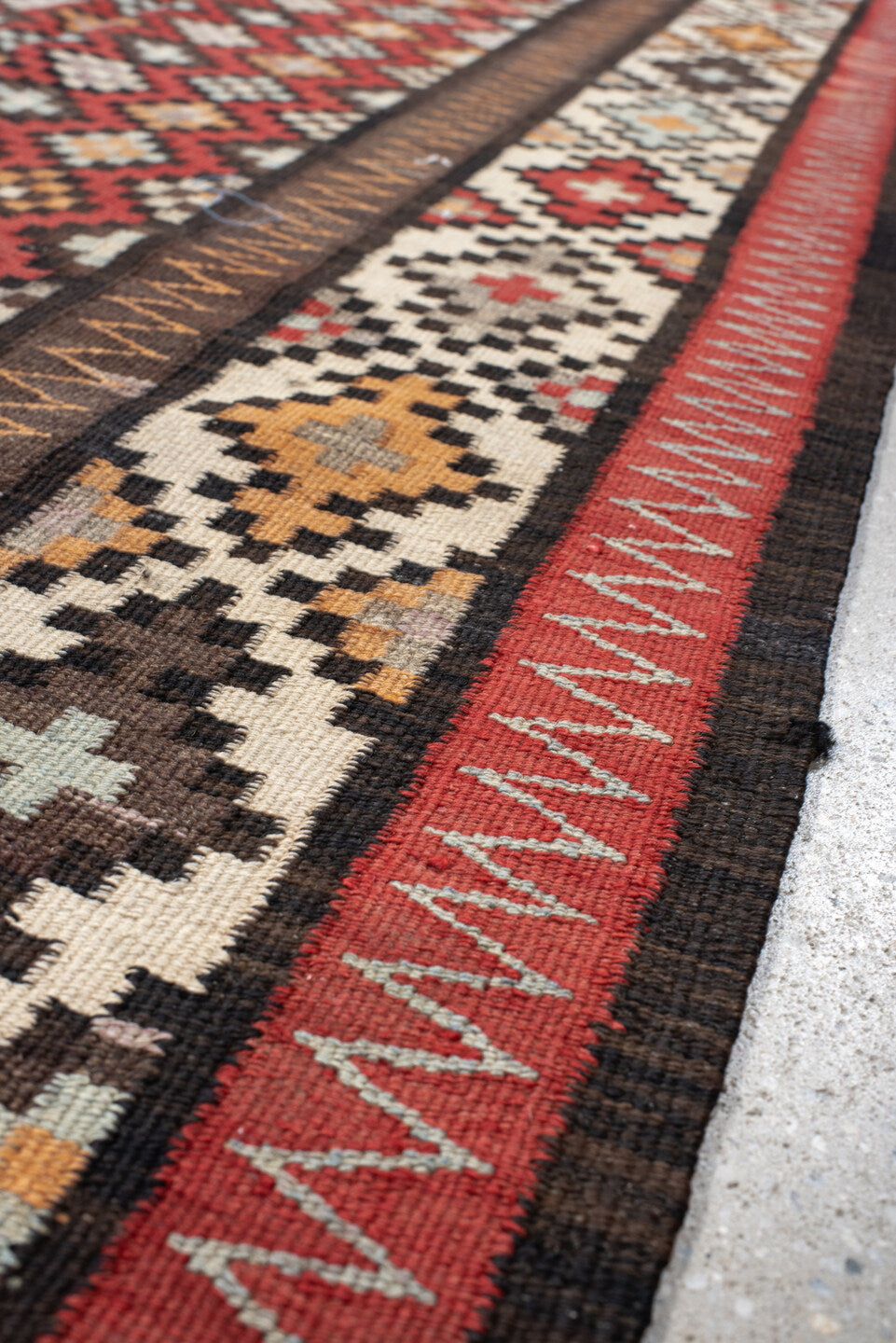 4' x 9' one-of-a-kind handmade vintage Kilim runner rug. Color palette: rust, ivory, charcoal, brown, sky blue, saffron