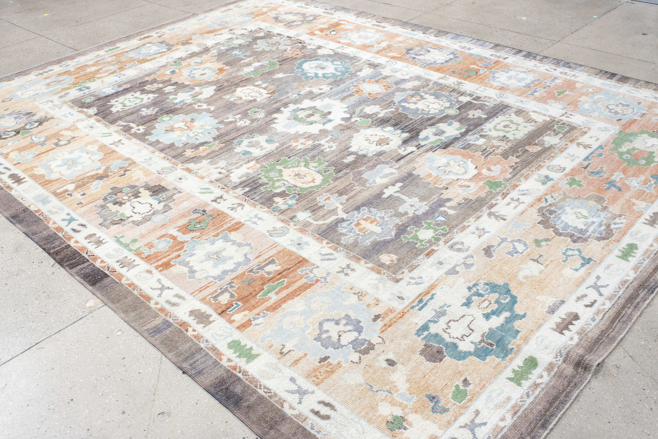 9' x 11' one-of-a-kind handmade vintage Oushak large size rug. Color palette: charcoal, apricot, ivory, sky blue, sage