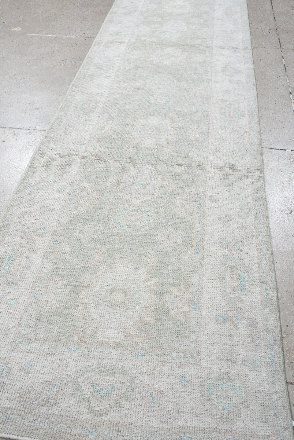2' x 10' one-of-a-kind handmade vintage Oushak runner rug. Color palette: ivory, pale blue, cream, light gray, light blue