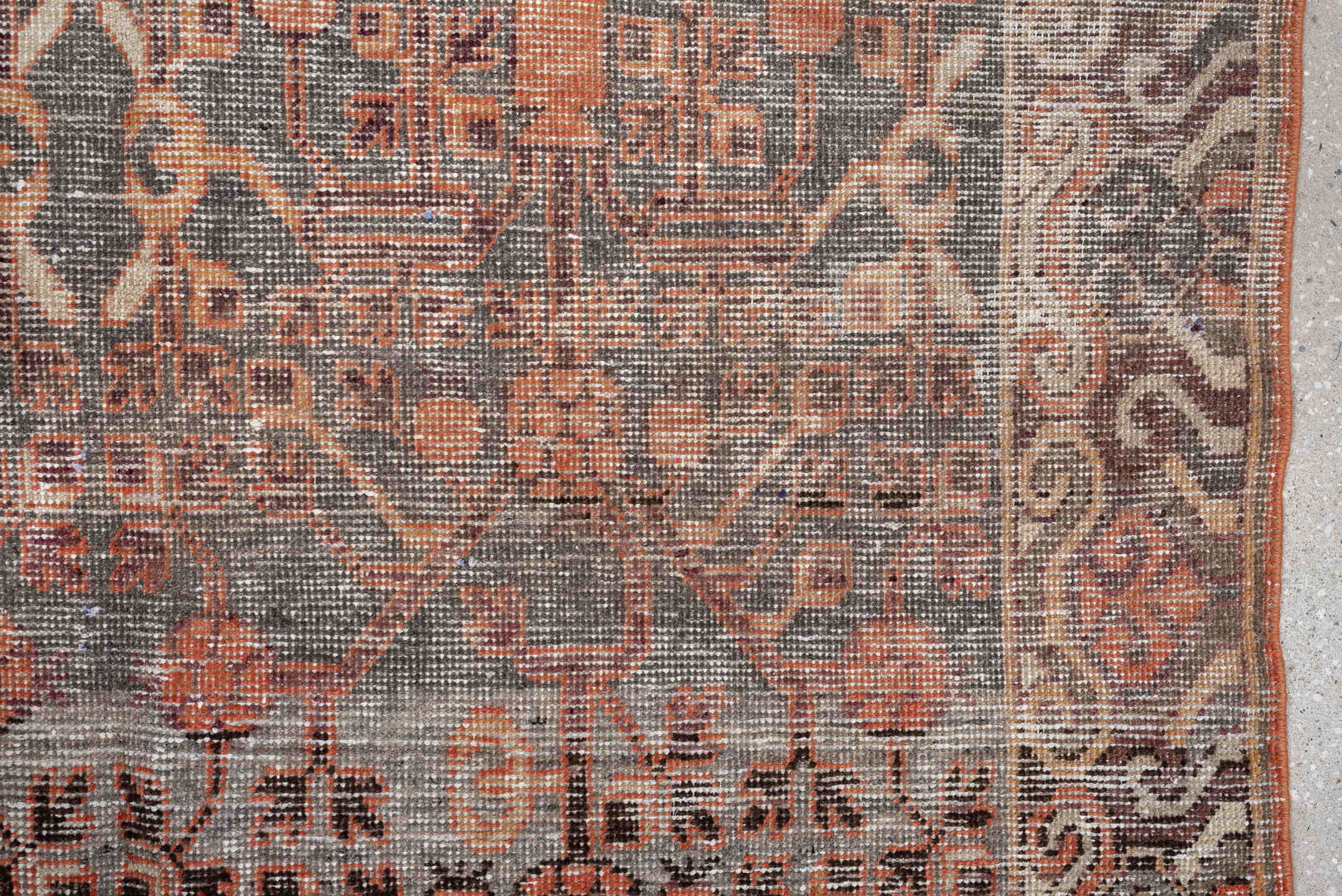 4' x 7' one-of-a-kind handmade antique  rug. Color palette: charcoal, coral, ivory, taupe, slate, terra cotta, brown, black