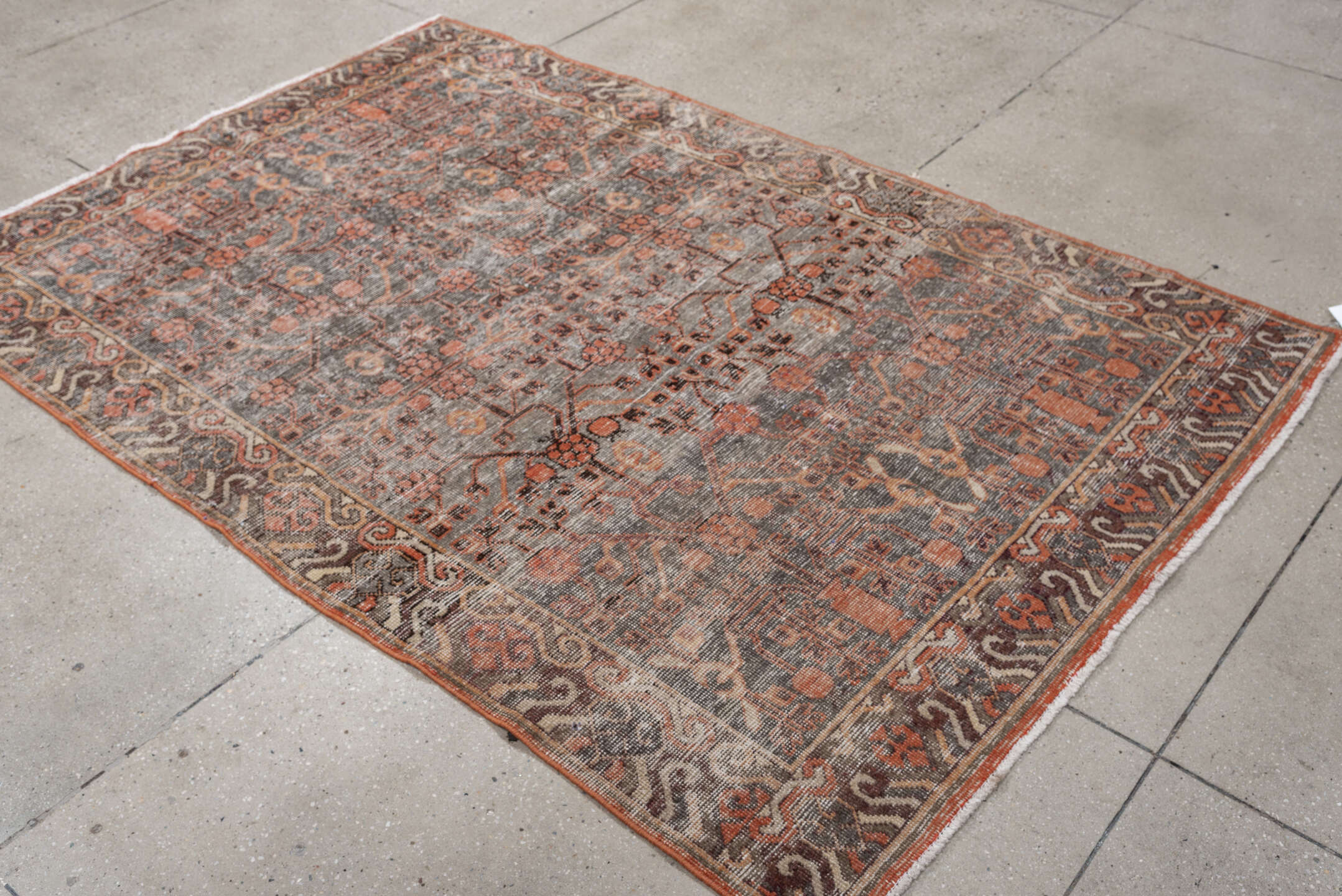 4' x 7' one-of-a-kind handmade antique  rug. Color palette: charcoal, coral, ivory, taupe, slate, terra cotta, brown, black
