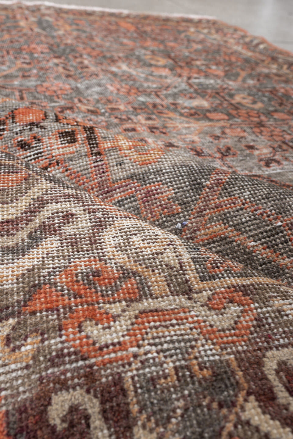 4' x 7' one-of-a-kind handmade antique  rug. Color palette: charcoal, coral, ivory, taupe, slate, terra cotta, brown, black