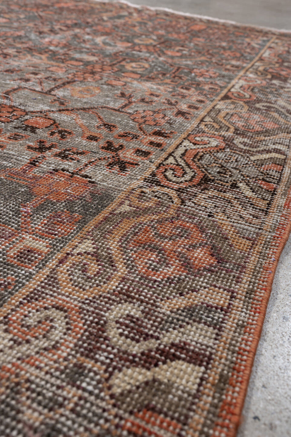 4' x 7' one-of-a-kind handmade antique  rug. Color palette: charcoal, coral, ivory, taupe, slate, terra cotta, brown, black