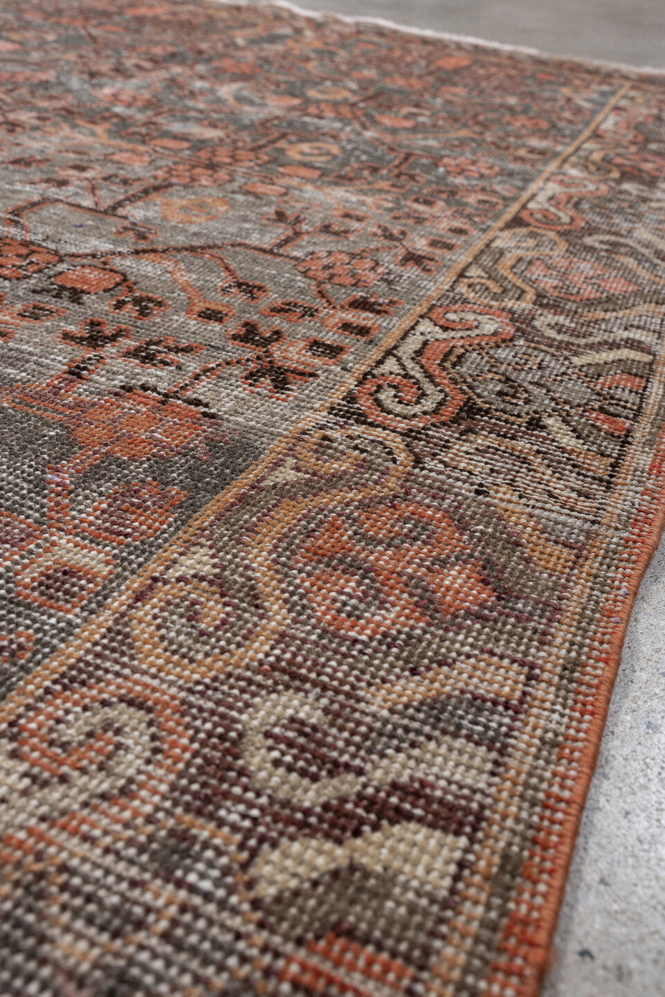 4' x 7' one-of-a-kind handmade antique  rug. Color palette: charcoal, coral, ivory, taupe, slate, terra cotta, brown, black
