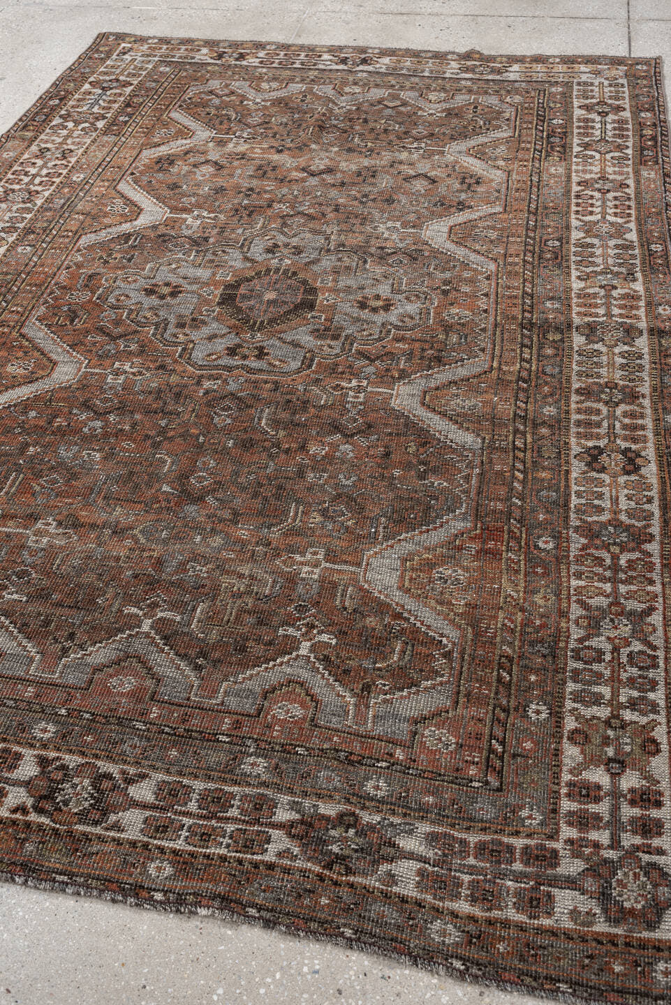 5' x 7' one-of-a-kind handmade antique Shiraz medium size rug. Color palette: rust, brown, ivory, taupe, charcoal, camel