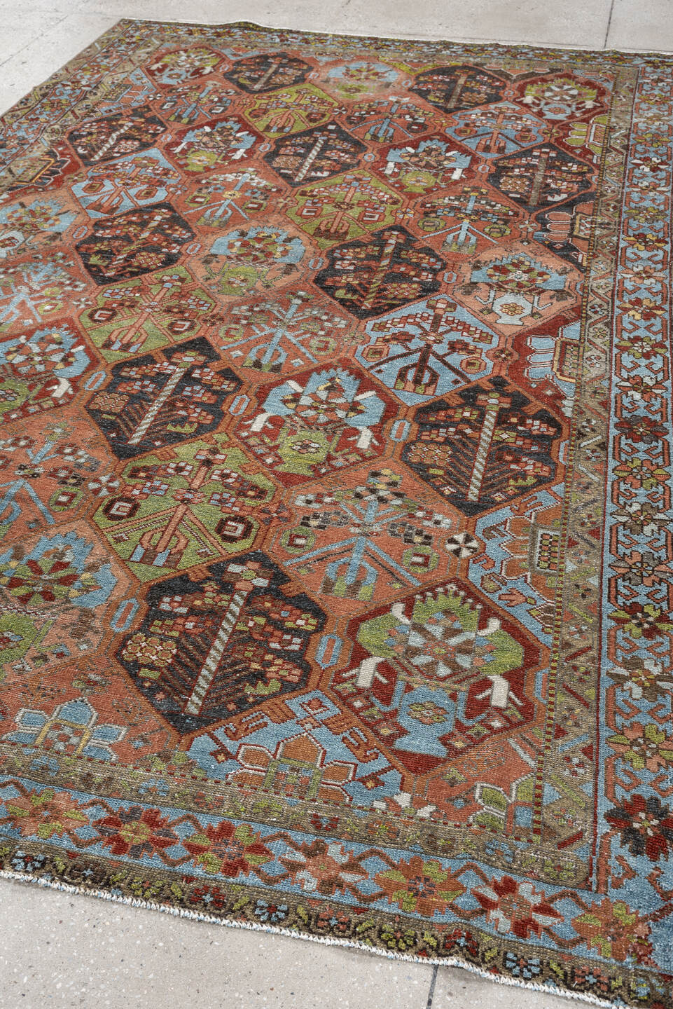 6' x 9' one-of-a-kind handmade antique Baktiary large size rug. Color palette: terra cotta, sky blue, olive, ivory, navy