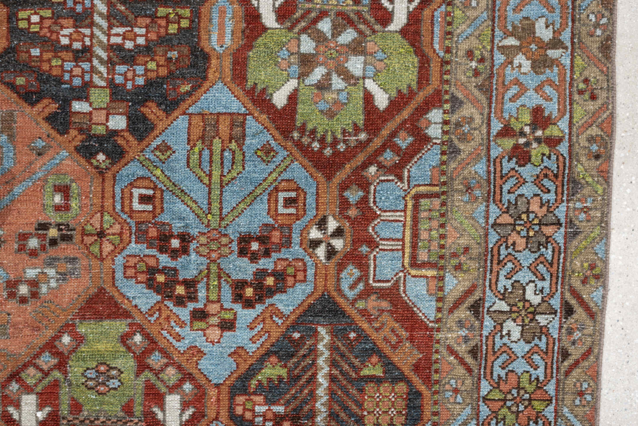 6' x 9' one-of-a-kind handmade antique Baktiary large size rug. Color palette: terra cotta, sky blue, olive, ivory, navy
