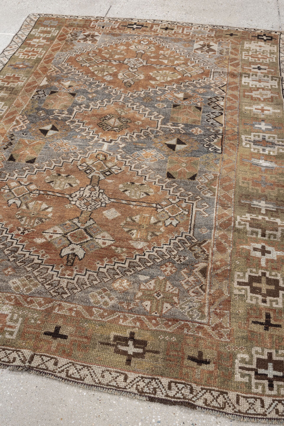 4' x 6' one-of-a-kind handmade antique Shiraz rug. Color palette: terra cotta, sage, ivory, charcoal, taupe, slate, camel