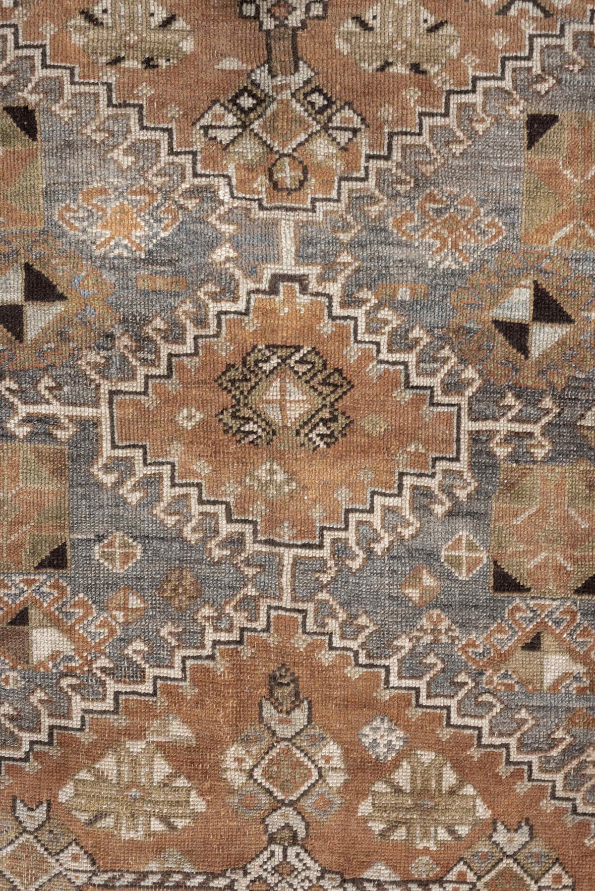 4' x 6' one-of-a-kind handmade antique Shiraz rug. Color palette: terra cotta, sage, ivory, charcoal, taupe, slate, camel