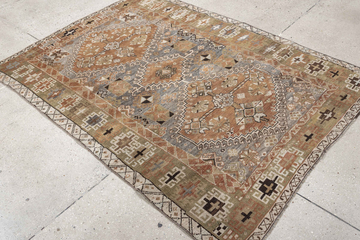 4' x 6' one-of-a-kind handmade antique Shiraz rug. Color palette: terra cotta, sage, ivory, charcoal, taupe, slate, camel